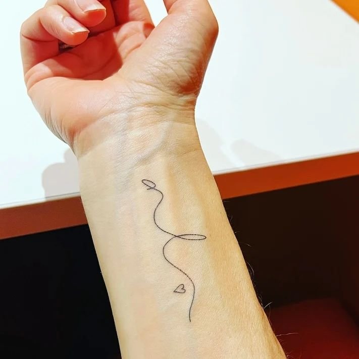 Elegance on Skin - Abstract Single-Line Tattoo