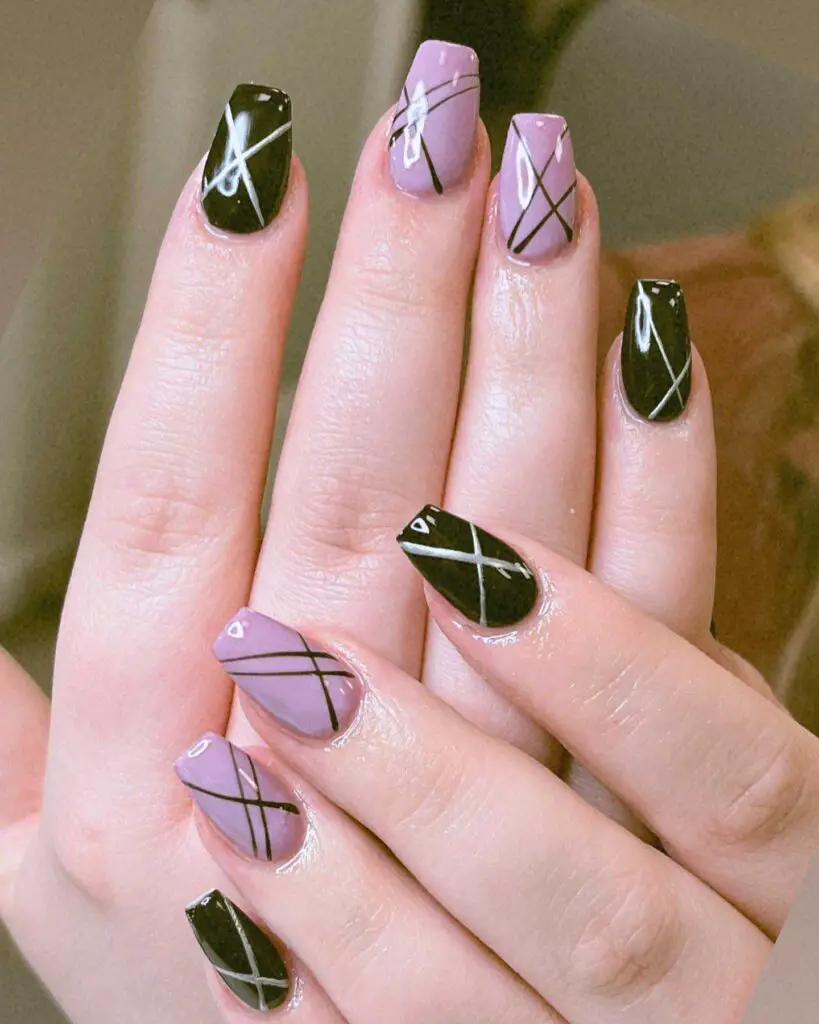 Black and lilac nails with white geometric lines offering a modern twist on the classic French manicure design.