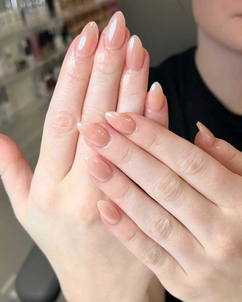 Glossy, sheer nude nails embodying natural beauty and sophistication, suitable for any occasion.