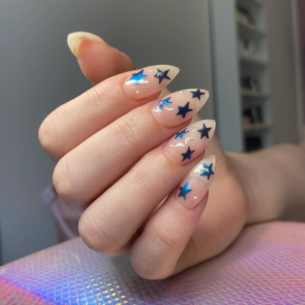 Starry Elegance: A dash of celestial charm graces a nude base, with glittering blue stars offering a glimpse into the night sky at your fingertips.