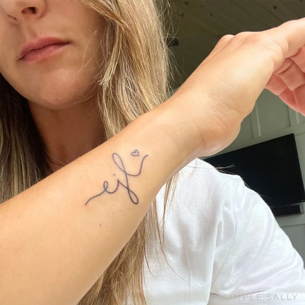 Elegant Flourish - Initials Tattoo on Forearm