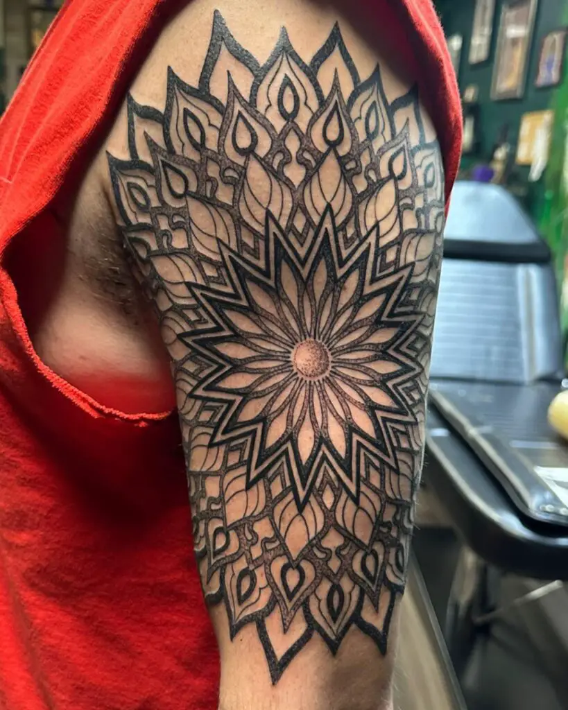 Shoulder tattoo of a lotus mandala with intricate detailing, symbolizing growth and enlightenment.