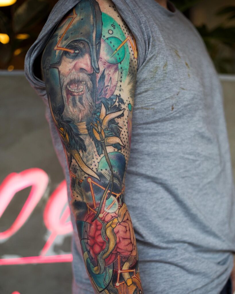 A colorful tattoo sleeve of a Viking in berserker rage, symbolizing unleashed power and ferocity.