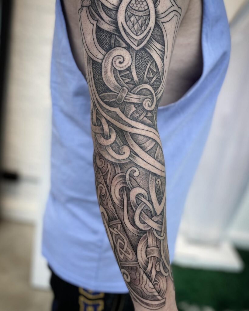 A forearm adorned with complex Celtic knotwork, symbolizing eternity and life's continuous journey.