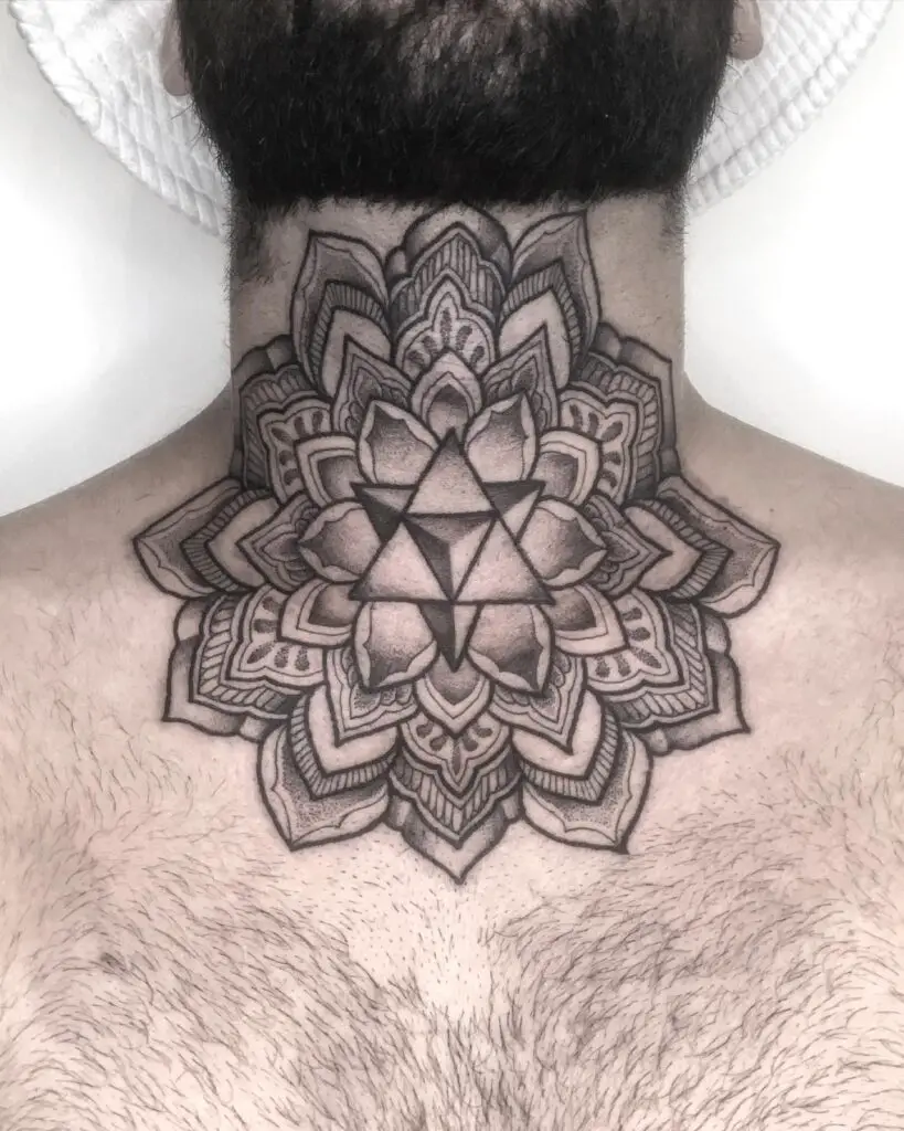 A large mandala tattoo on the back of the neck with intricate floral and geometric patterns extending to the upper back.