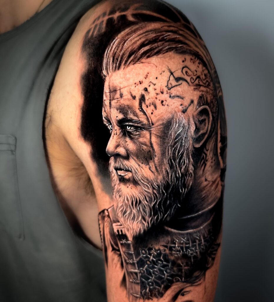 A colorful, realistic sleeve tattoo of a Viking with runic inscriptions, blending tradition with modern art.