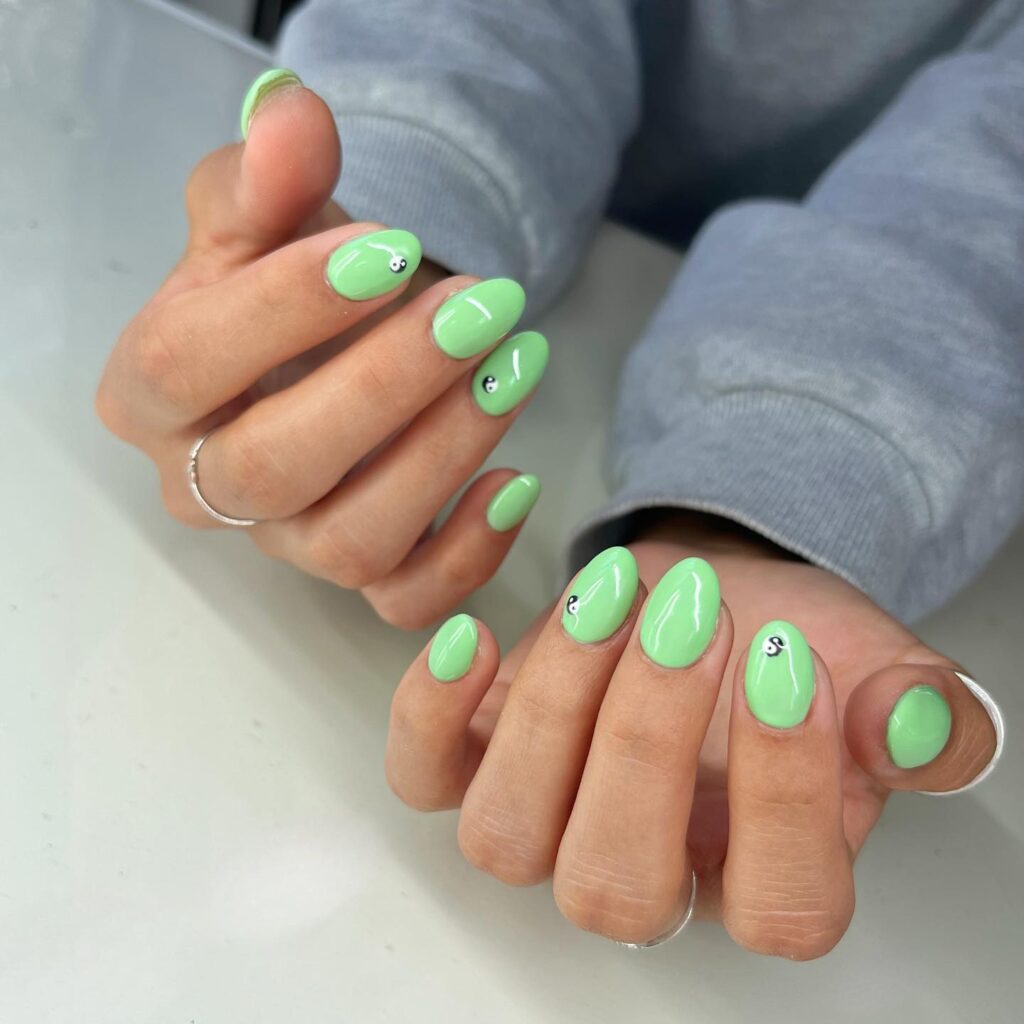 Joyful Greens: A cheerful burst of mint green paired with smiley faces on these nails injects a playful personality into your style.