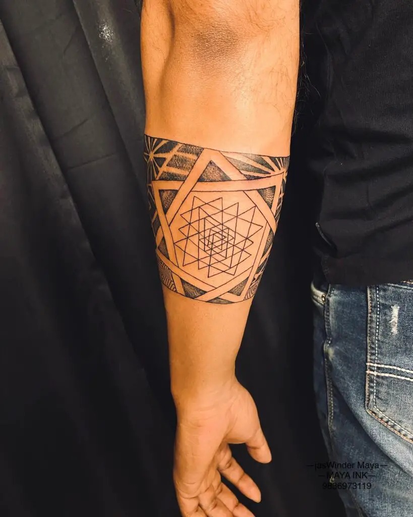A striking geometric mandala tattoo covering the calf with bold black areas and contrasting patterns.