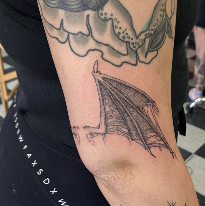 A tattoo of a sailing ship with full sails on the forearm, representing adventure and life's journey.