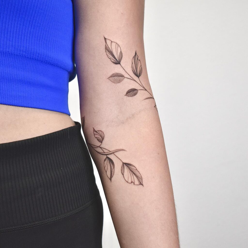 Nature's Whispers: Elegant Botanical Arm Tattoo