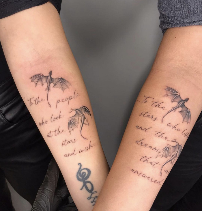 Twin forearm tattoos with dragons and inspirational quotes about stars and dreams, representing wishful thinking and fulfillment.