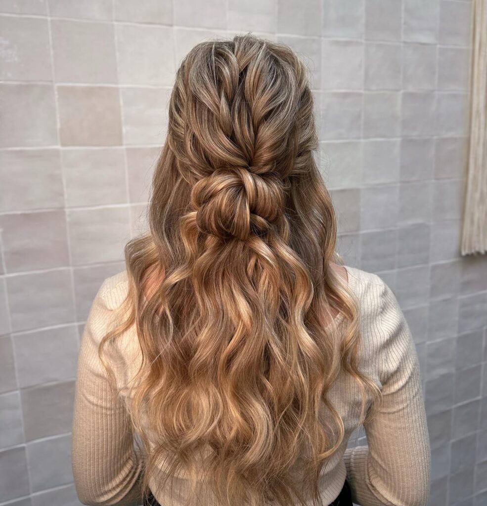 A fishtail braid transitions into soft, caramel-toned curls for a dreamy prom hairstyle.