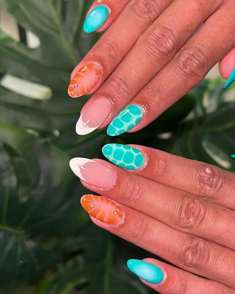 Hands with a mix of orange and turquoise nails, some with a honeycomb pattern, evoking a tropical summer vibe.