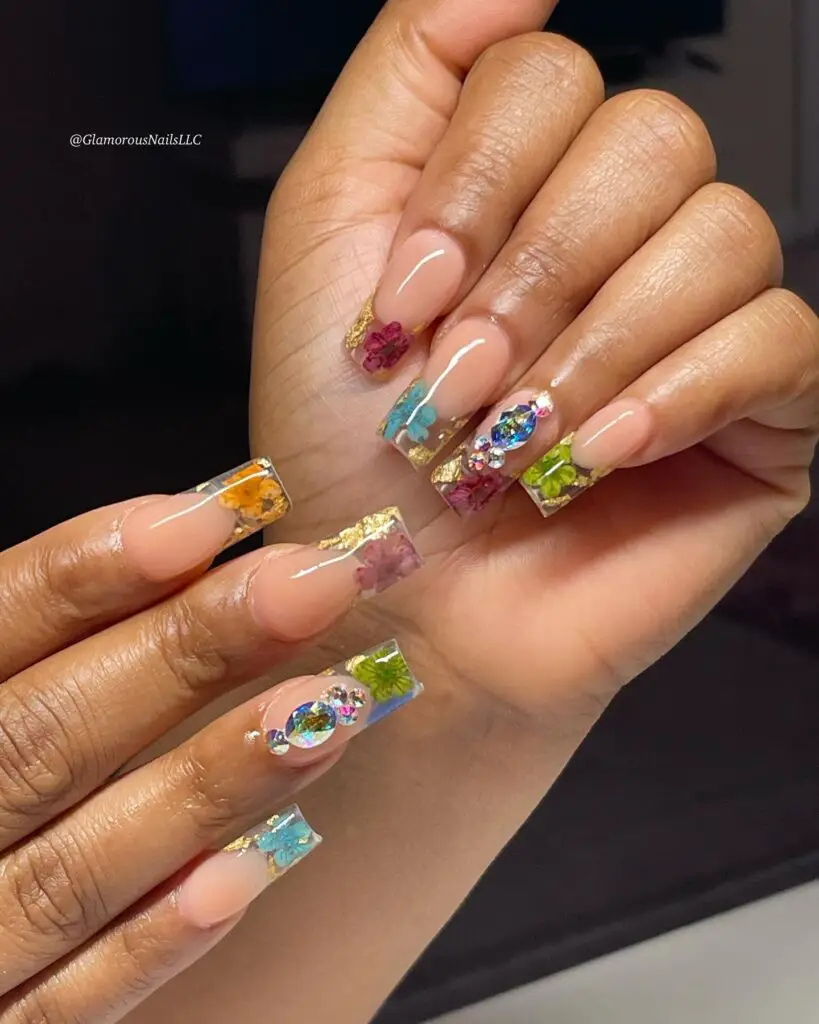 A mix of animal print and floral patterns adorning the nails, offering an eclectic and stylish safari-inspired nail art look.