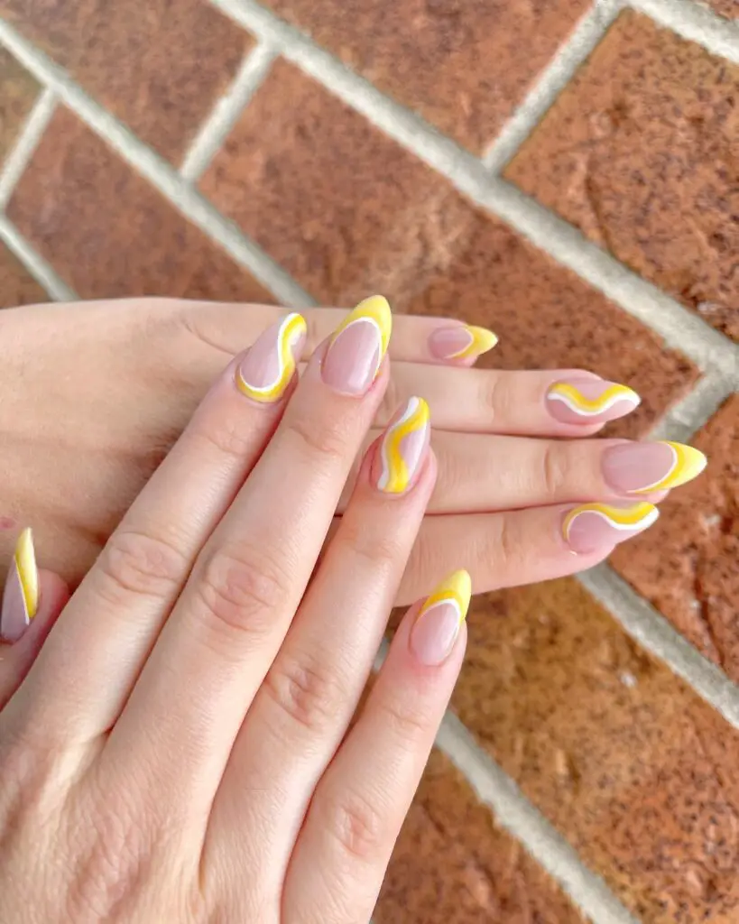 Yellow and white wavy patterns over a translucent pink base, exuding the joy and warmth of a manicure inspired by sunny days.