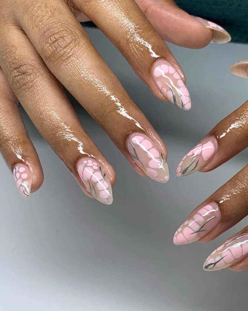Elegant pink marble nail design with white veining, reminiscent of gentle flower petals.