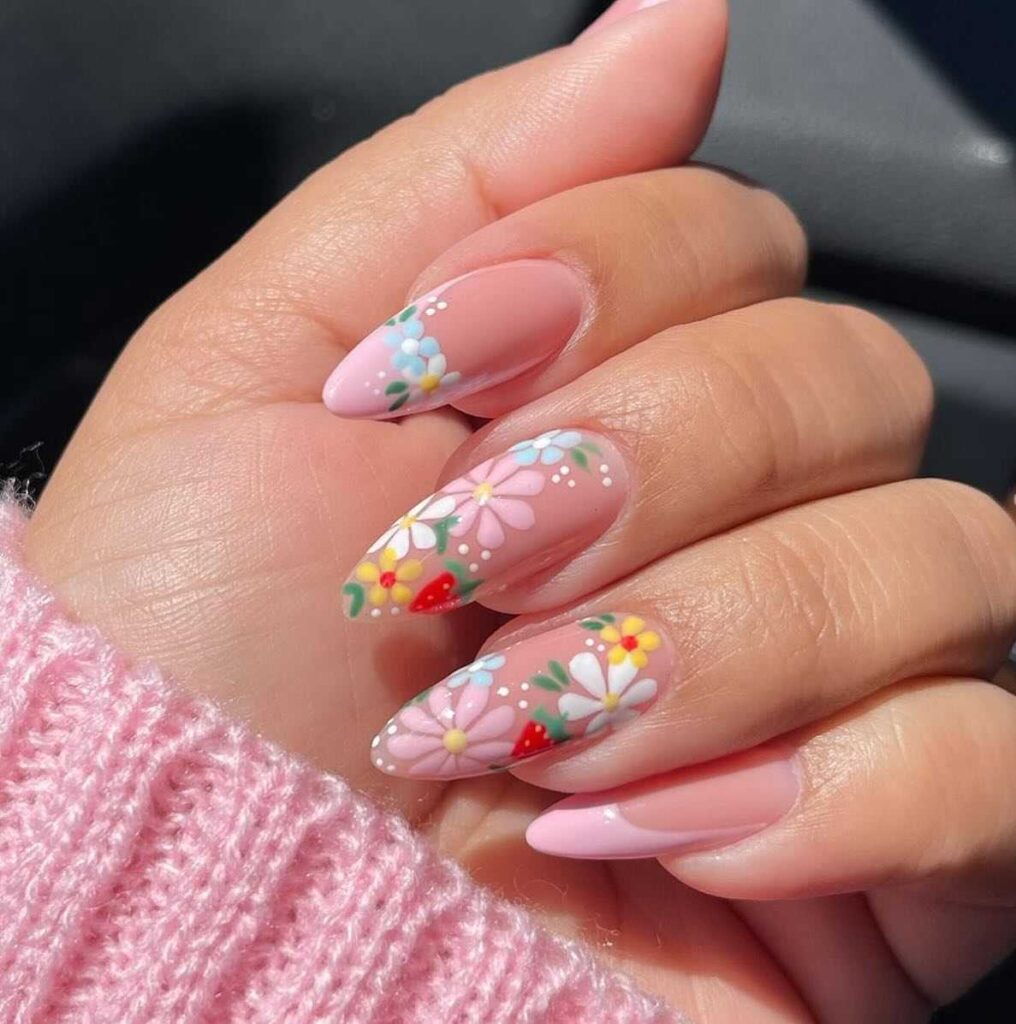 Pink pastel nails adorned with white daisies and subtle polka dots, embodying the essence of spring.