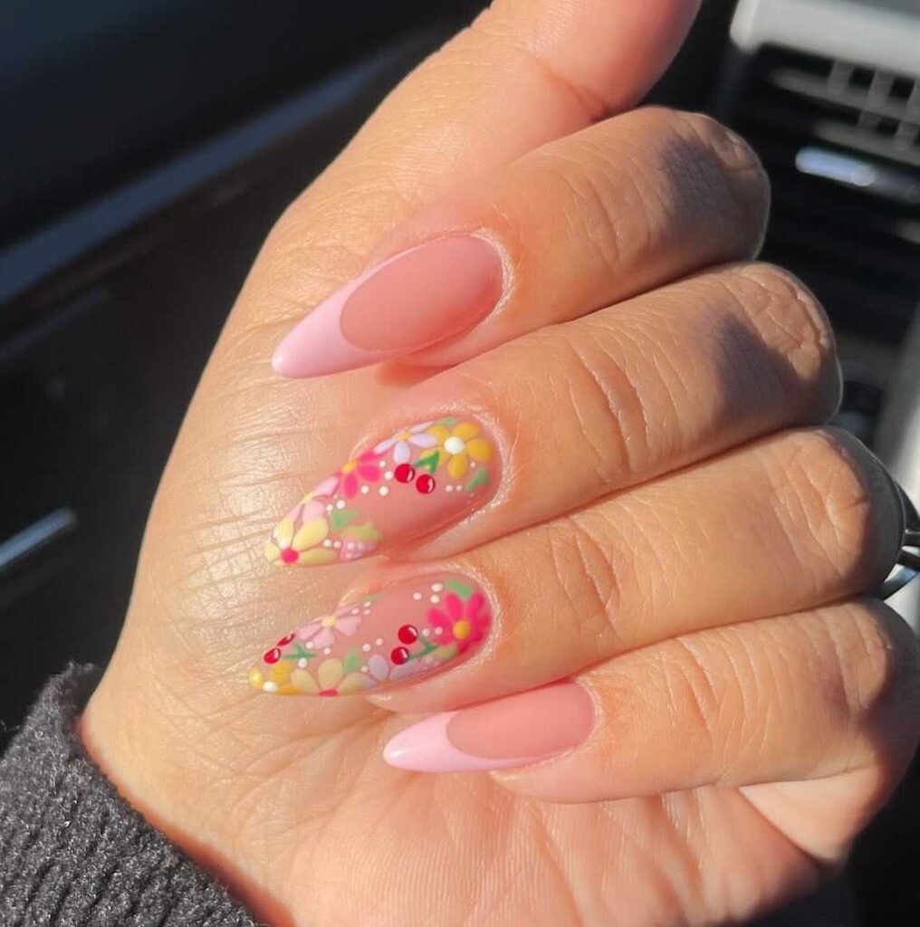 Vivid spring nail art with hot pink accents and yellow tropical-inspired floral patterns.
