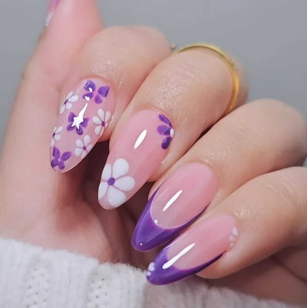 Almond-shaped nails with a floral pattern transitioning from lavender to clear, evoking a spring garden aesthetic.