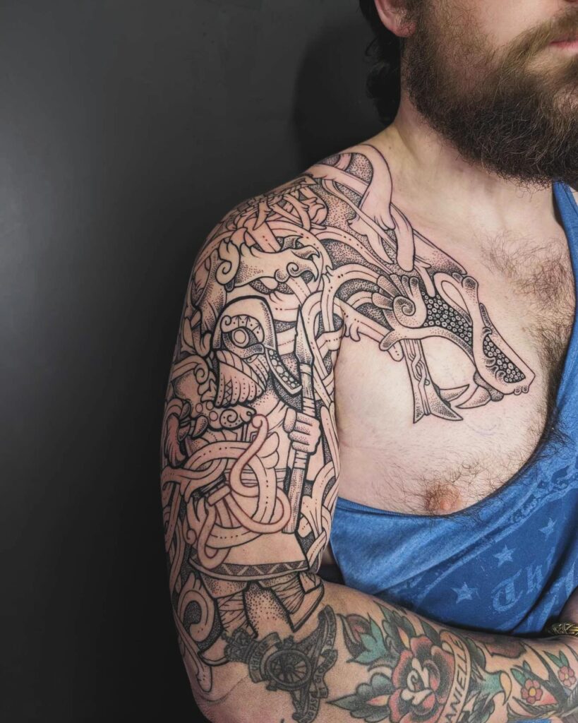 A tattoo sleeve rich with Viking mythical beasts and serpentine creatures in an ornate design.