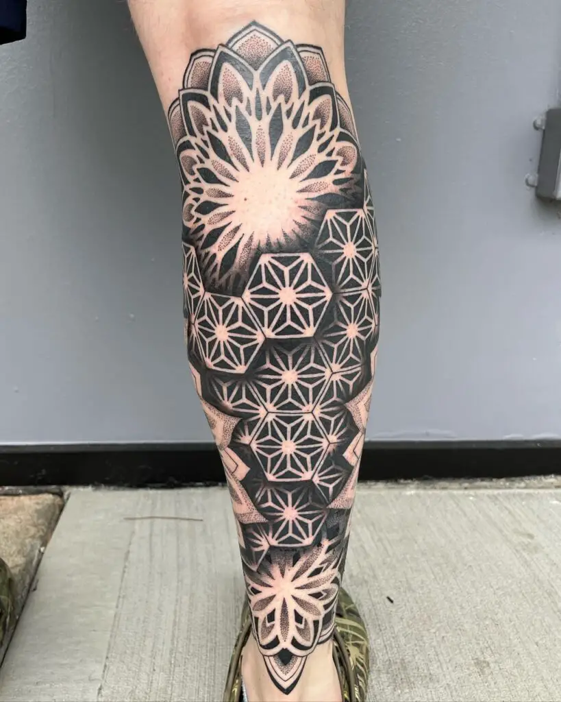 Full-length leg tattoo with a variety of mandala patterns, creating an intricate tapestry of black ink designs.
