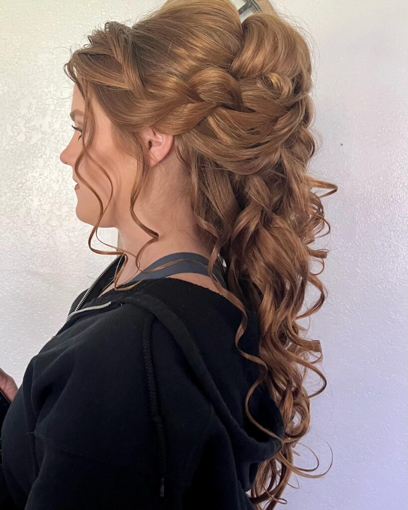 A profile view of a woman's elegant updo with twists and curls, offering a majestic and sophisticated hairstyle for prom night.