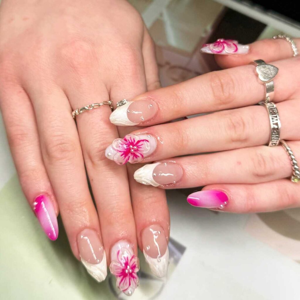 Nails with cherry blossom designs and a gentle pink gradient, embodying the delicate beauty of spring blossoms.