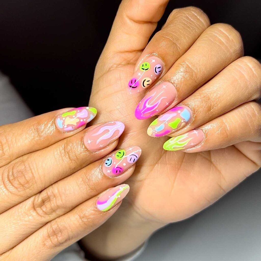 Vivid neon swirl patterns on pastel pink nails, creating a striking and playful nail art statement.