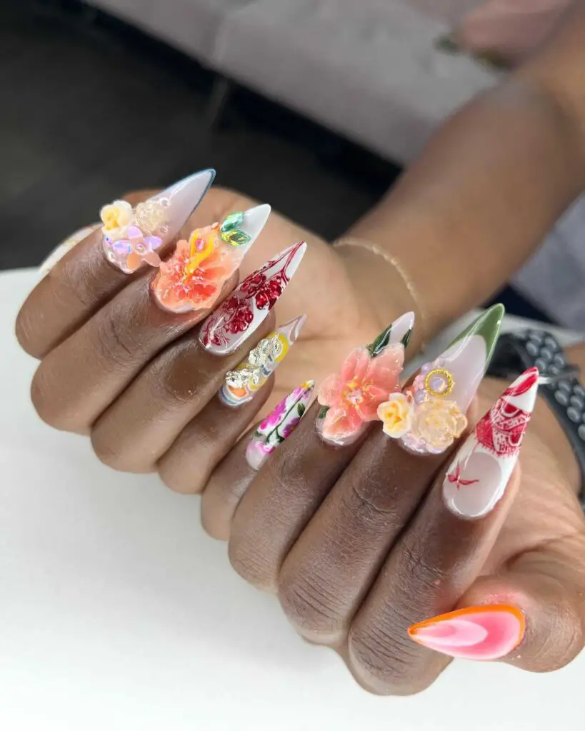 Elaborate 3D floral nail art with jeweled details, showcasing a luxurious and sculpted manicure style.
