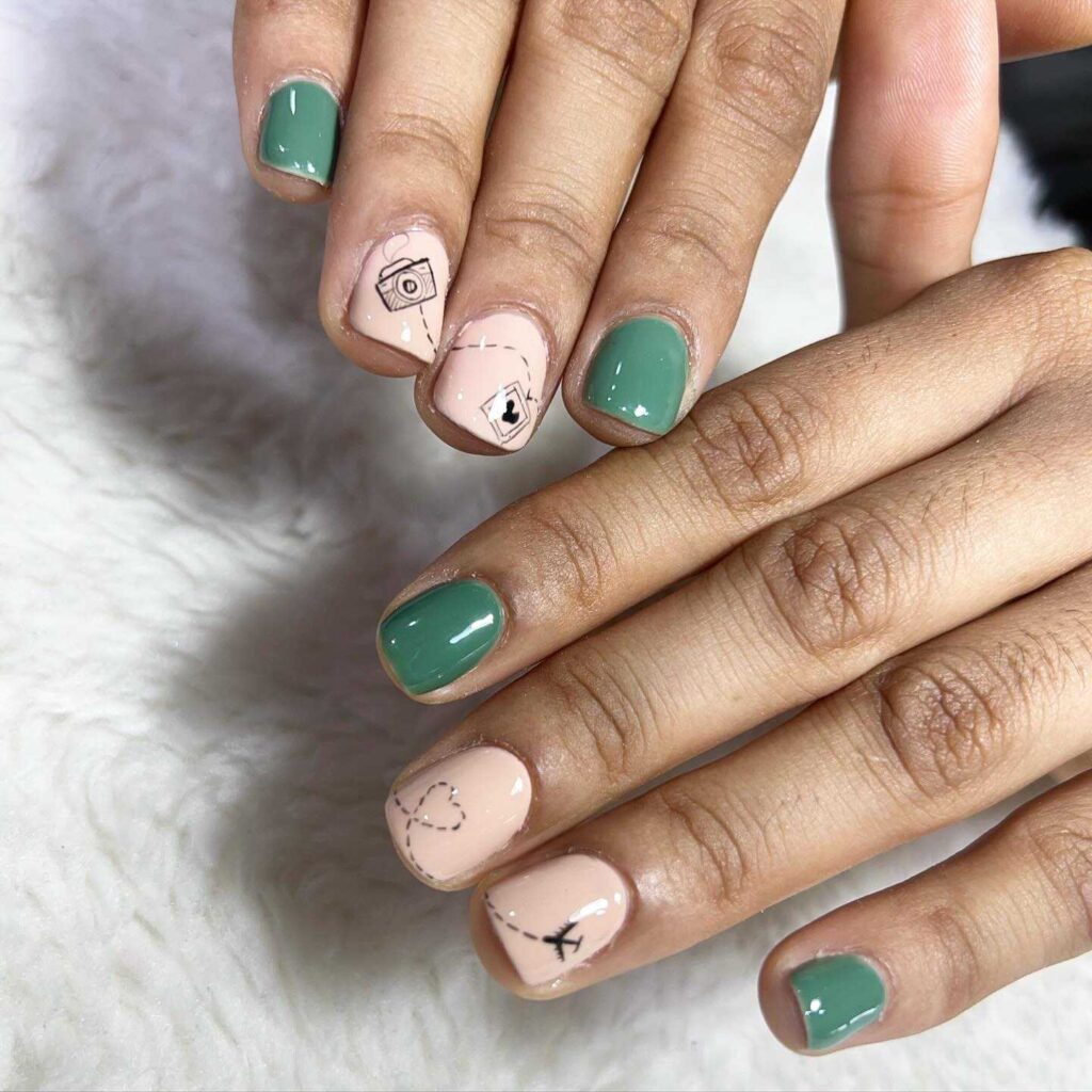 A combination of pastel pink and green nails featuring minimalist geometric shapes and line art for a contemporary look.