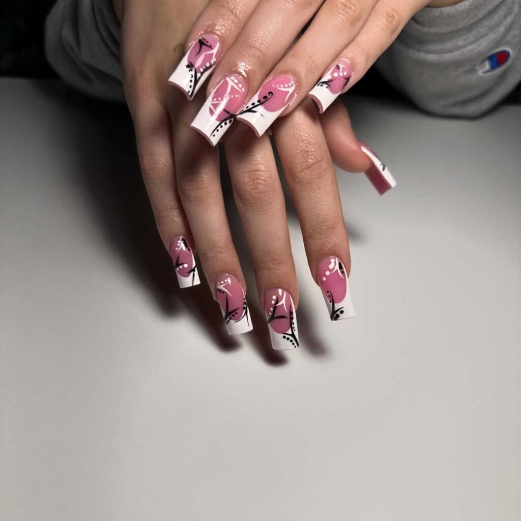 Coffin nails with a creative flamingo design in black and pink, presenting a bold and artistic nail art expression.