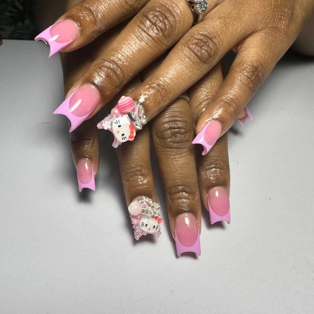 Bubblegum pink nails with whimsical 3D kitty accents, white highlights, and sparkling details for a playful look.
