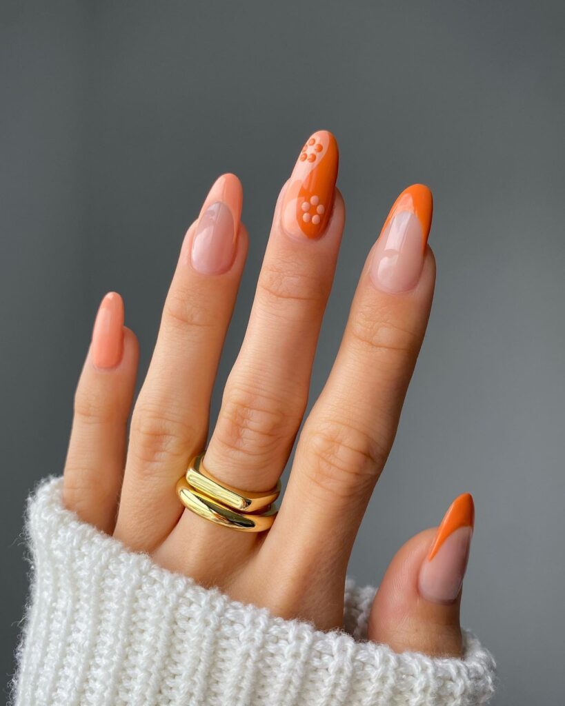 Peachy Twist: French Tips with Orange Flower Accent