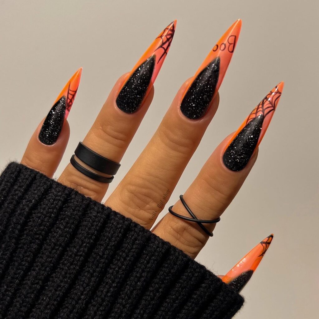 Spooky Sparkle: Black Glitter Nails with Orange Tips