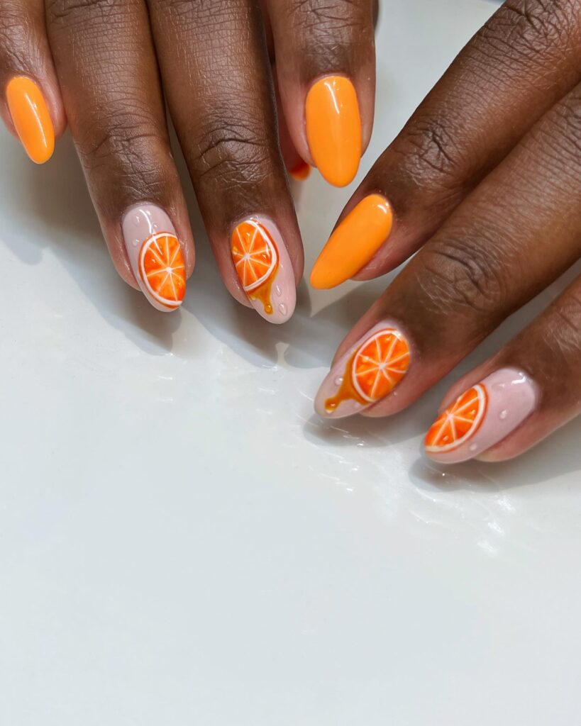 Sweet and Sassy: Peach Nails with Orange Slice Accents 