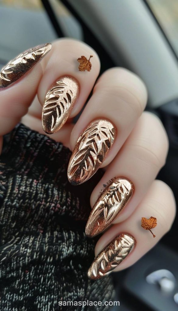 Coral nails with leaf detailing create a vibrant and lively look for casual fall days.